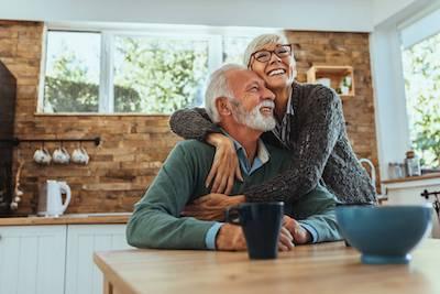 Couple smiling in their kitchen at home in Pikesville, MD