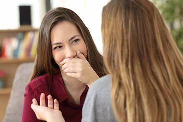 Woman covering her smile at cosmetic dentist in Pikesville, MD