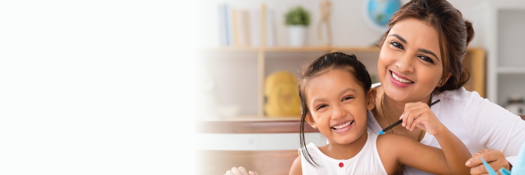 Woman & daughter painting and smiling after dental treatment in Pikesville MD