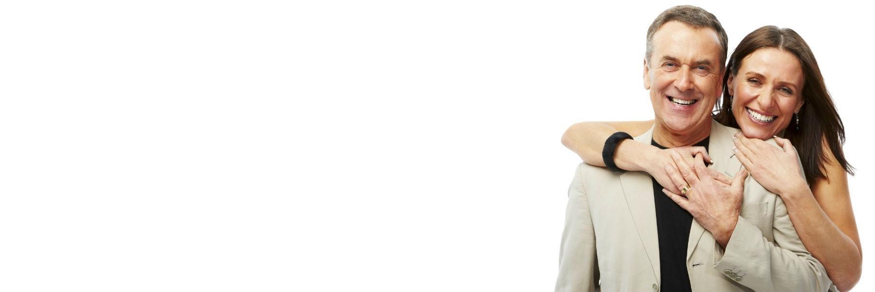 Older couple standing & smiling after dental treatment at Naylors Court Dental