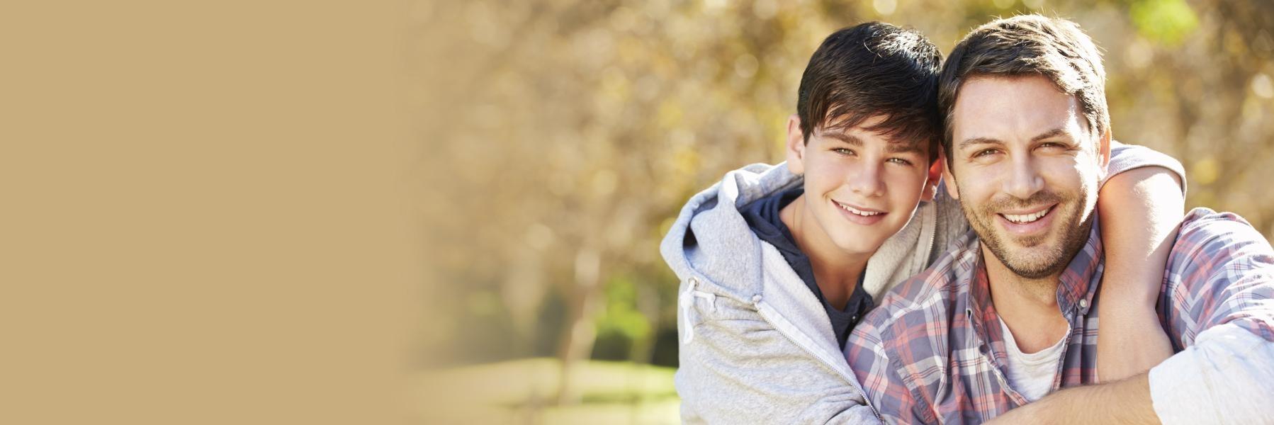 Father and son smiling & hugging after Teeth Whitening at Naylors Court Dental