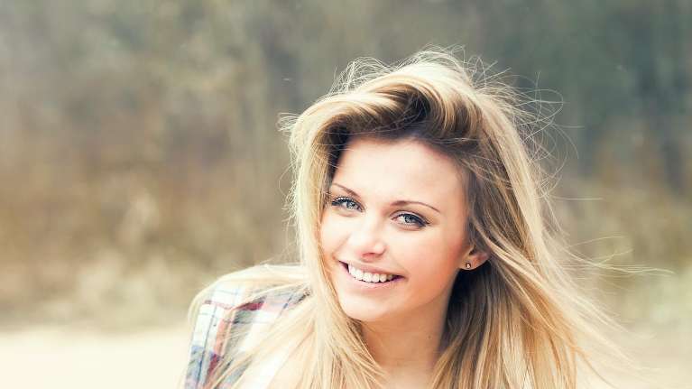 A happy client after an Effective, Efficient, and Safe Teeth Whitening in Pikesville, MD