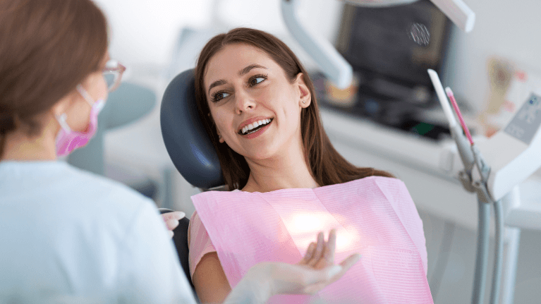 Patient smiling during dental check up ad examination in Pikesville, MD