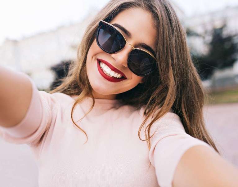 A woman smiling after getting a Cosmetic Dental Procedures in Pikesville, MD