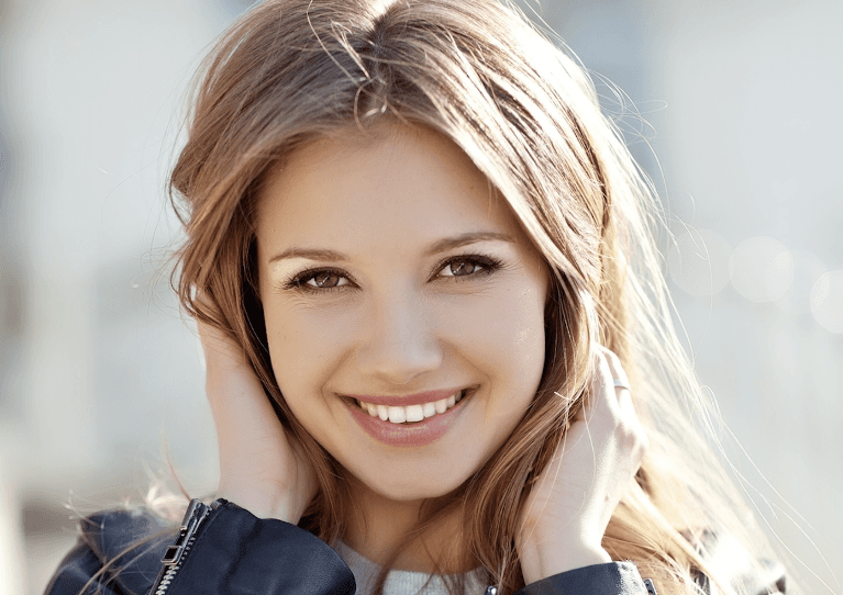 A young lady after visiting a Cosmetic Dentists in Pikesville, MD 