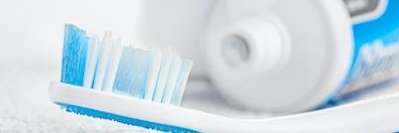 Close up of tooth brush and toothpaste in Pikesville, MD