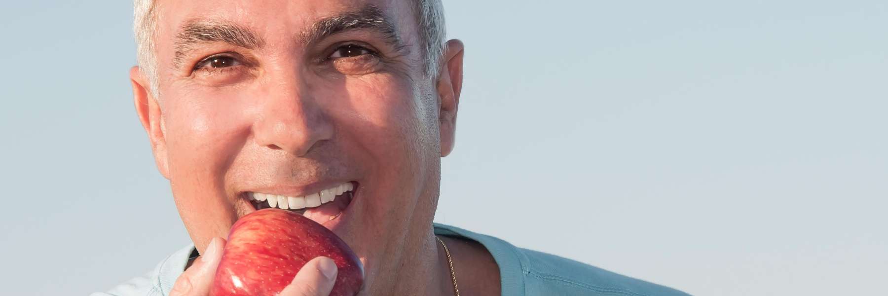 A gentleman biting an apple in Pikesville, MD.